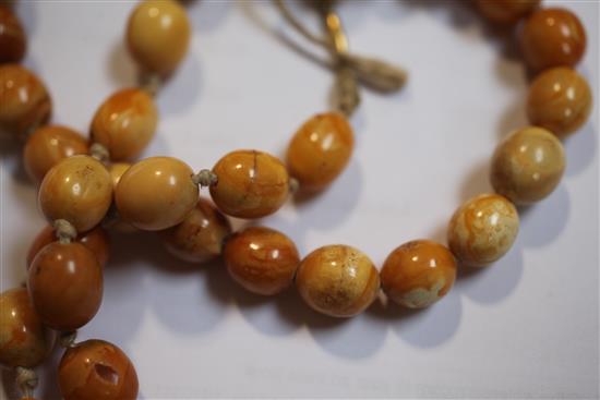 A single strand amber bead necklace and similar bracelet, gross weight 65 grams.